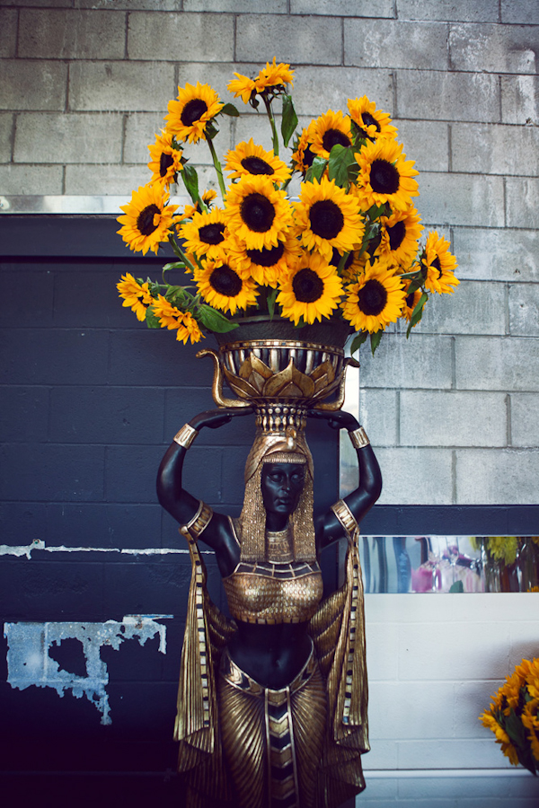 Egyptian statue decor with sunflower bouquet - vintage LA wedding at The Smog Shoppe photo by top Orange County wedding photographer Duke Images